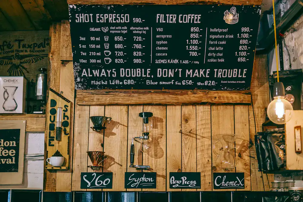 A vast wall of colourful board games in a cosy cafe