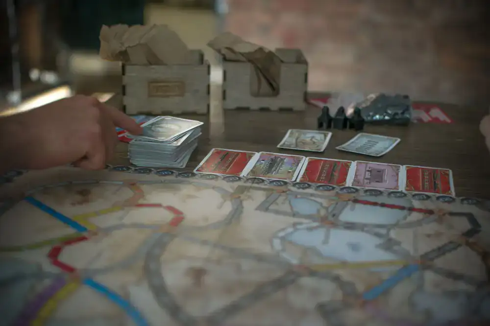 A neat sharing platter next to sleeved cards and wooden tokens