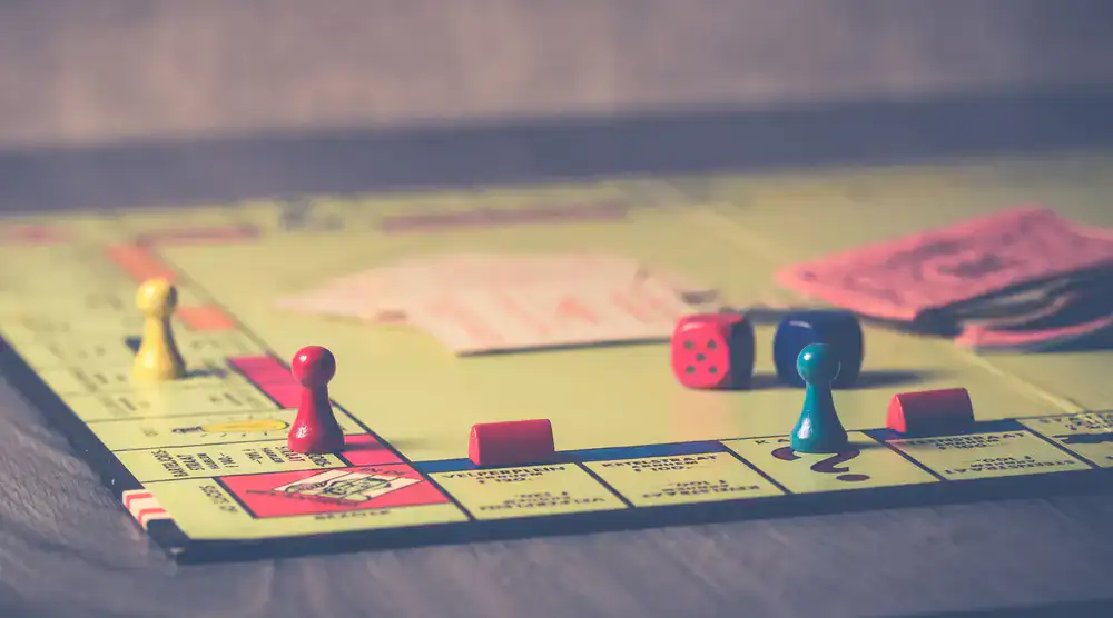 A friendly staff member explaining board game rules to a group