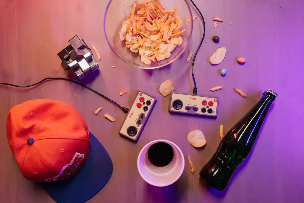 A vibrant assortment of café drinks and snacks arranged around a board game in progress
