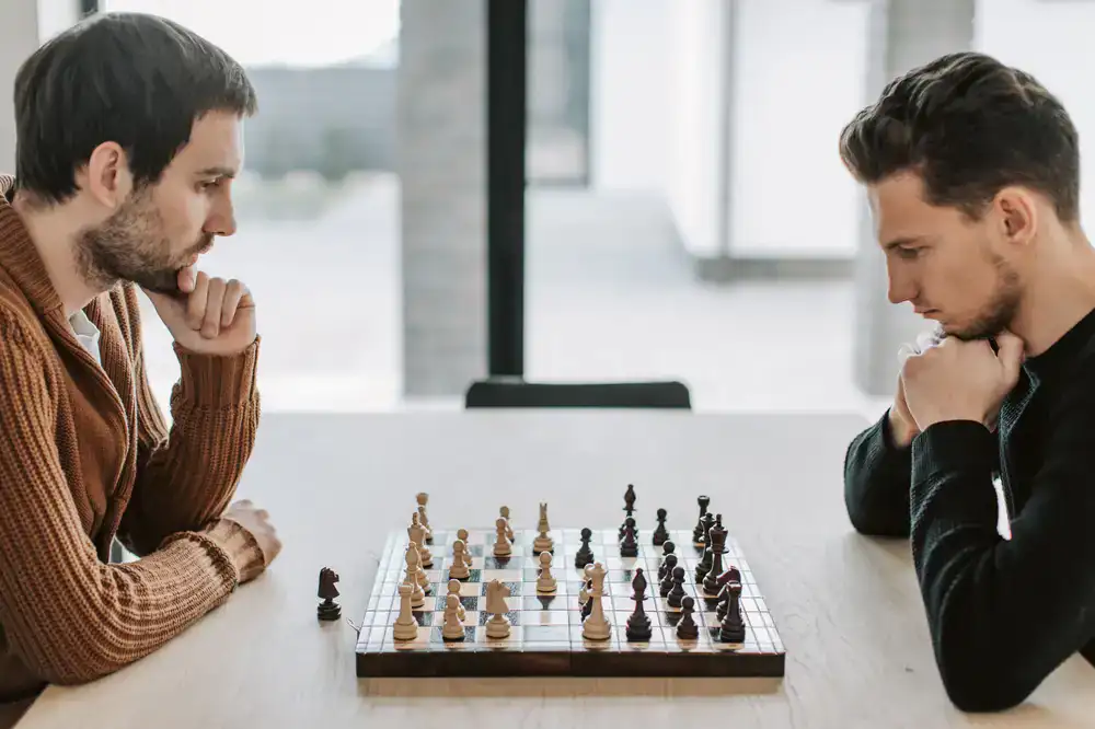 Two people deeply focused on a head-to-head board game
